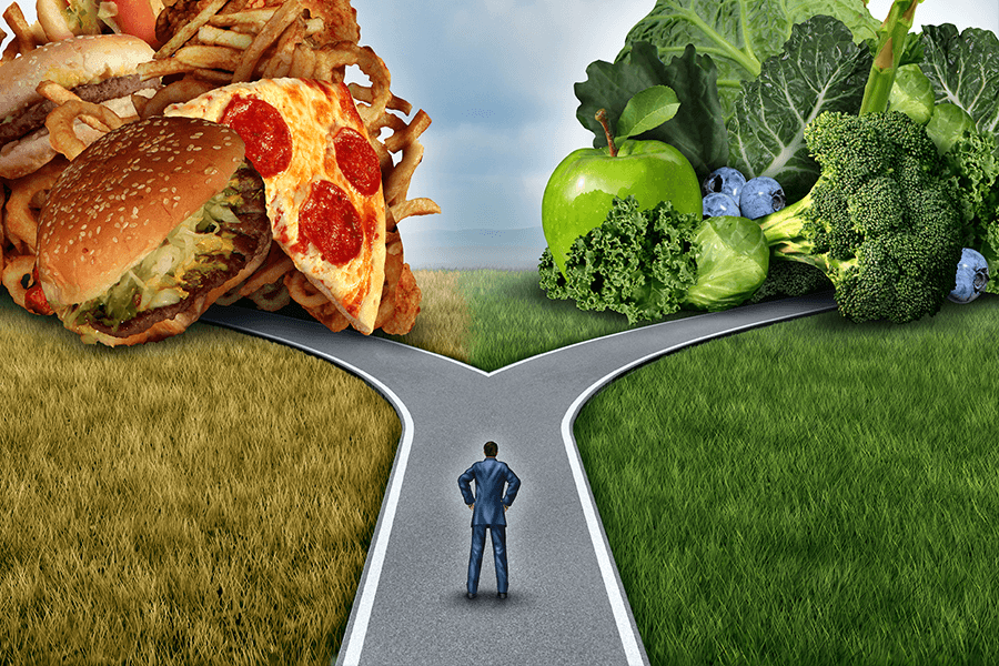Illustration of a man at a fork in a road: one road leads to junk food and the other to healthy food