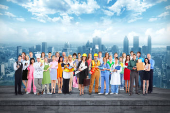 A wide range of different kinds of workers stood in front of a cityscape