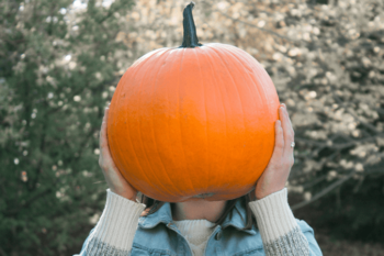 Woman holding a large pumpkin