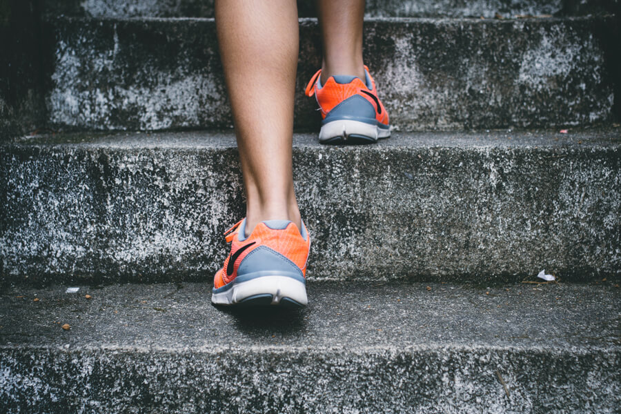 A runner climbing stairs