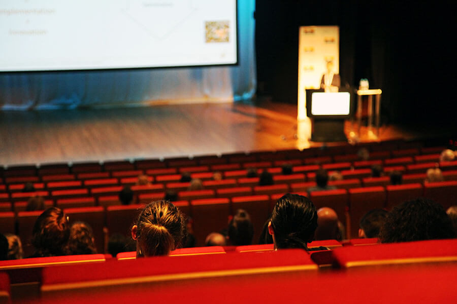 Auditorium in Brisbane with a conference speaker addressing the audience