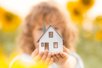 child holding tiny house model