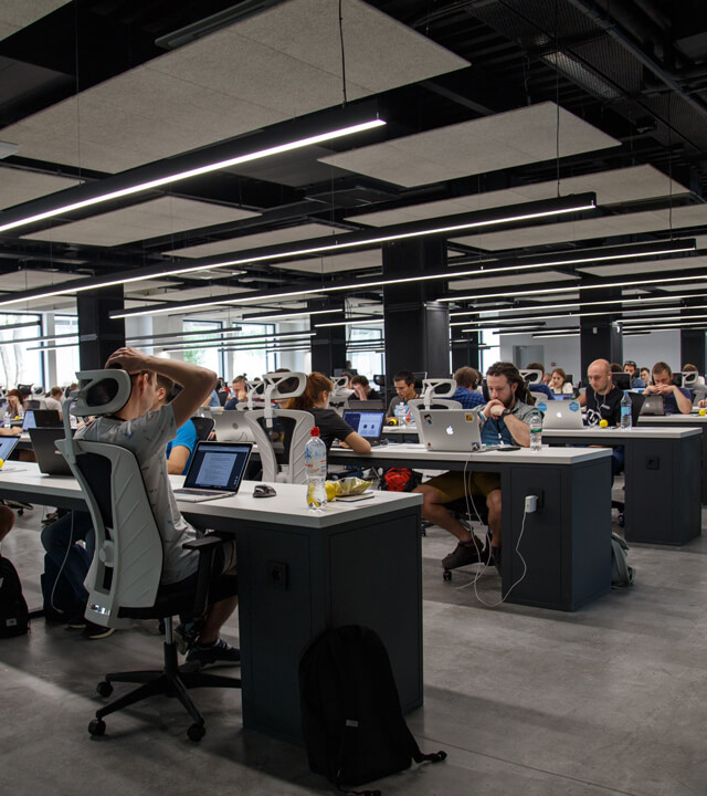 A busy modern office full of people at desks. Photo by Alex Kotliarskyi on Unsplash