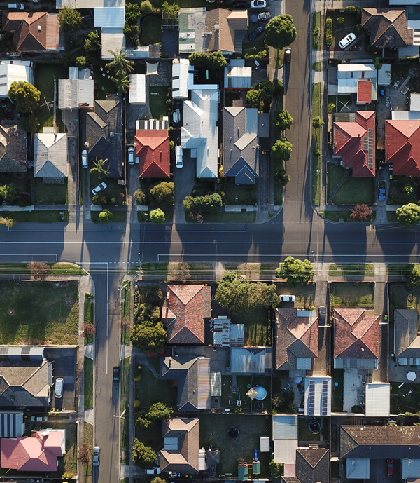 Birds eye view of symmetrical suburban streets in Melbourne, Australia, caught in the long afternoon shadows. Photo by Tom Rumble on Unsplash