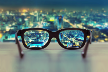 Eye glasses magnifying cityscape at night