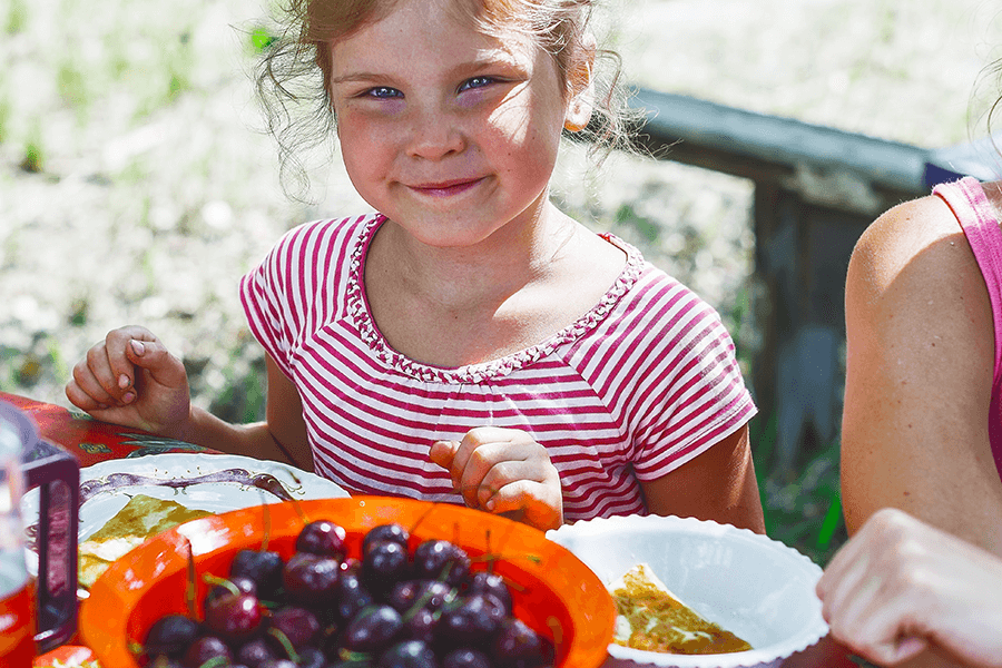 Healthy child eating fruit