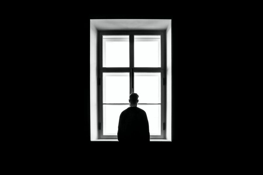 Man staring through a window