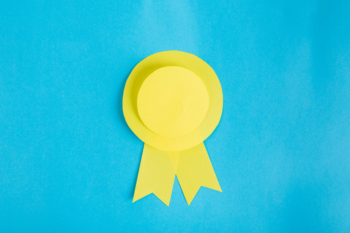 Yellow paper ribbon on blue background