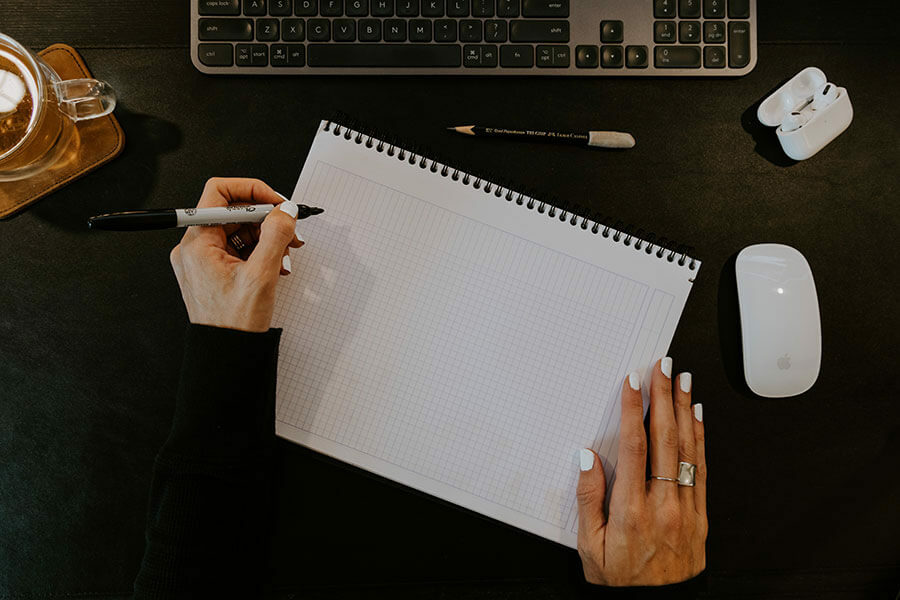 A person is about to start sketching out a diagram at their desk. Image by Kelly Sikkema on Unsplash.
