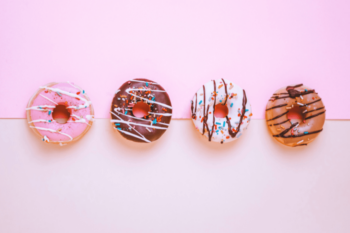 Donuts with colourful icing and sprinkles