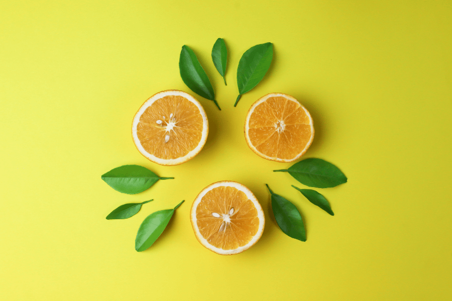 Oranges cut open on yellow background