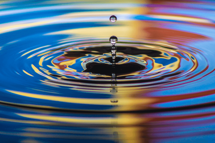 Ripple in water rainbow colours