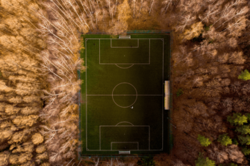 Aerial shot of soccer field with tall trees around