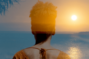 Woman looking at horizon sunset over ocean