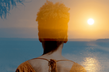 Woman looking at horizon sunset over ocean