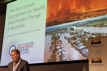Man in front of conference slide on climate change