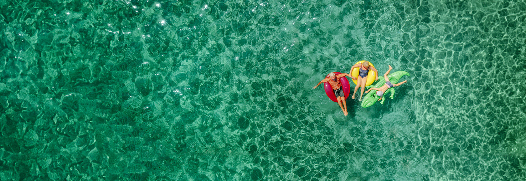 Aerial shot of people on floaties in a pool