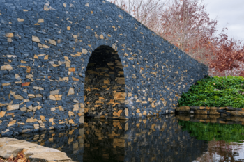 Archway of stone bridge over waterway